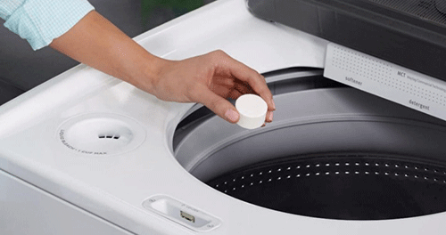 Woman cleaning Maytag Washing Machine