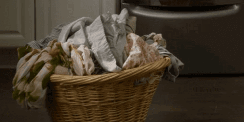 Laundry basket in front of Maytag washing machine